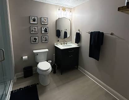 Modern basement bathroom vanity and toilet area in Plain City, OH