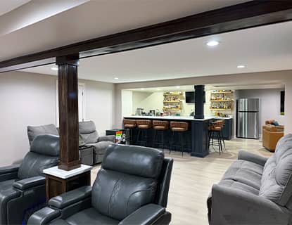 Finished basement living area with exposed beams and custom bar in a Plain City, OH home