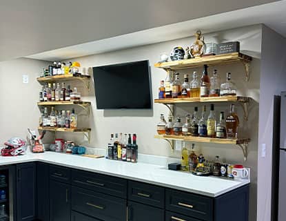 Modern wet bar with beverage fridge in a Plain City, OH finished basement