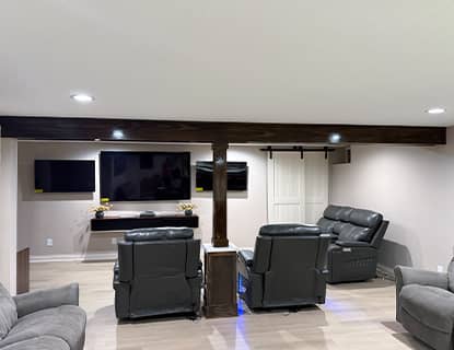 Finished basement seating area with multiple TVs in a Plain City, OH home